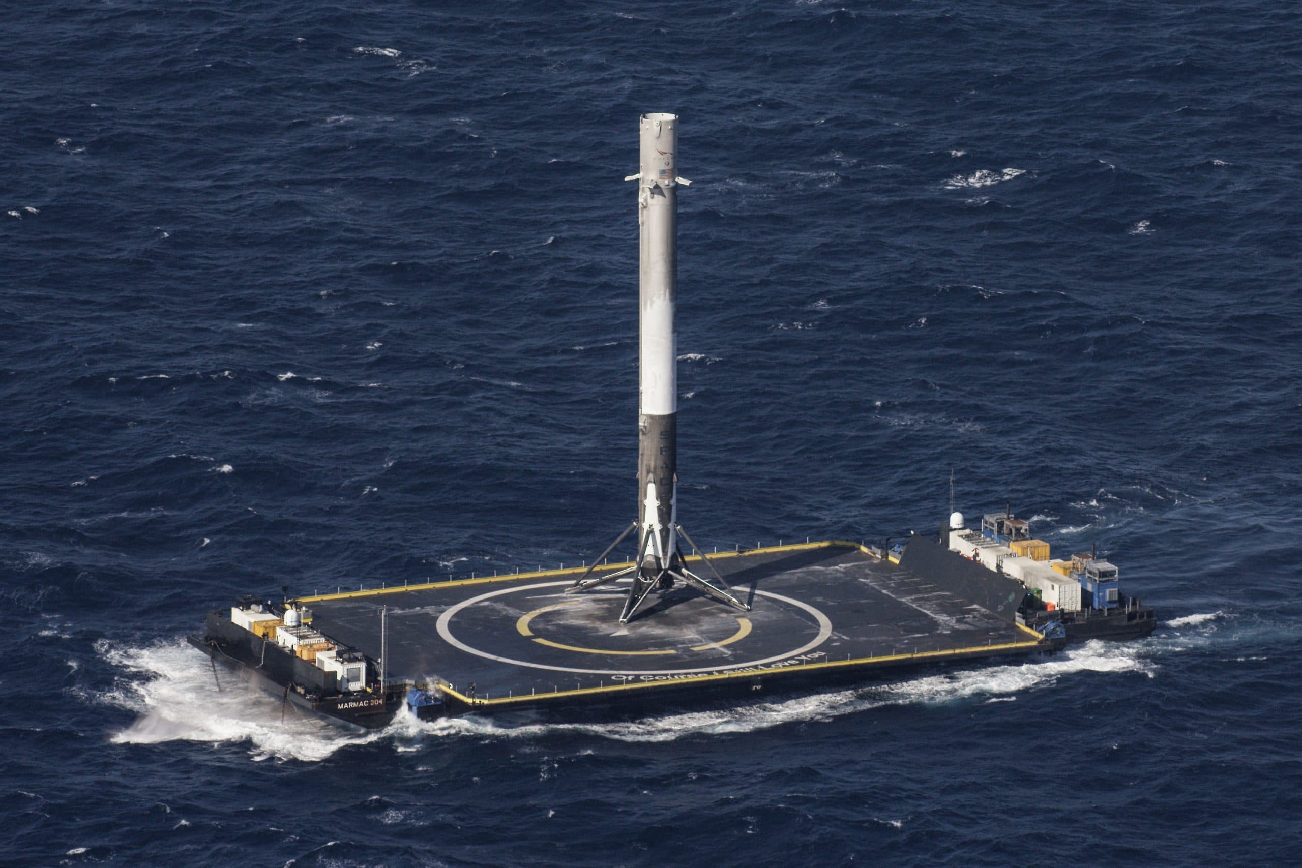 SpaceX Falcon 9 rocket landing on a drone ship at sea.